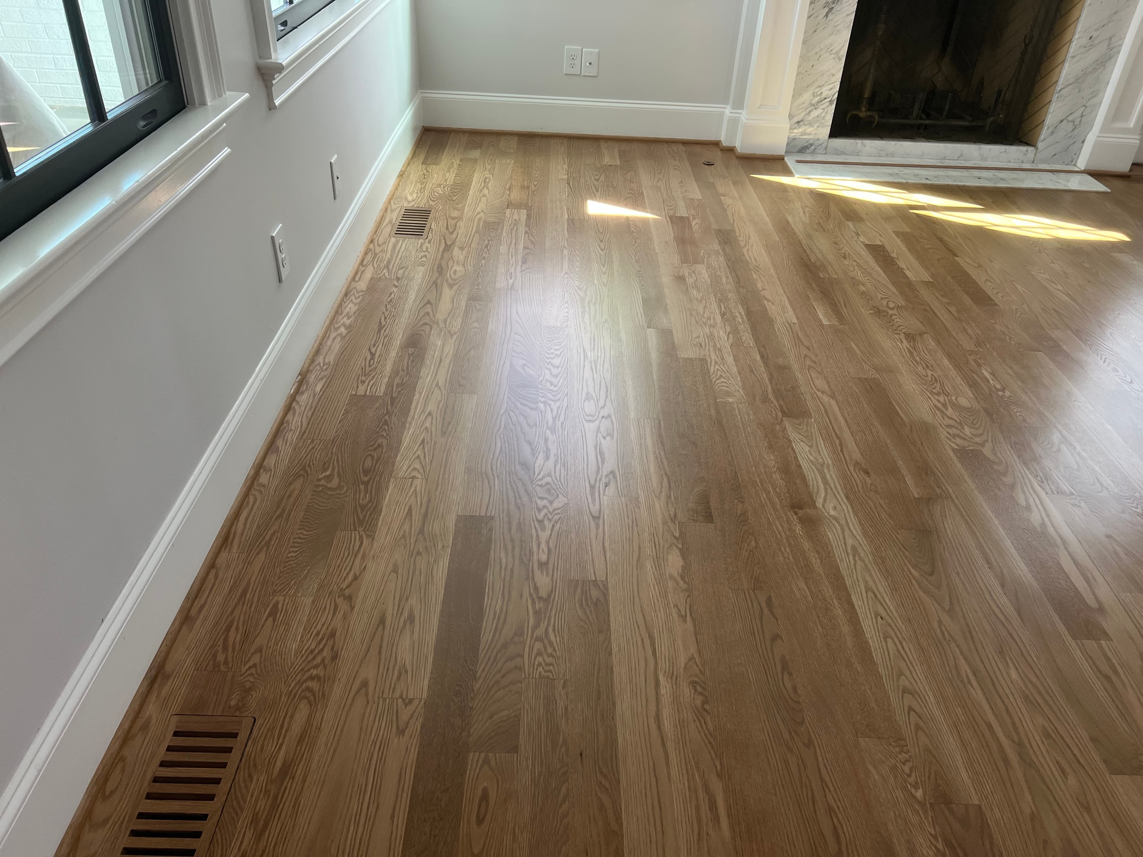 Custom flush mount hardwood floor vent installed flush with surrounding boards Clayton NC