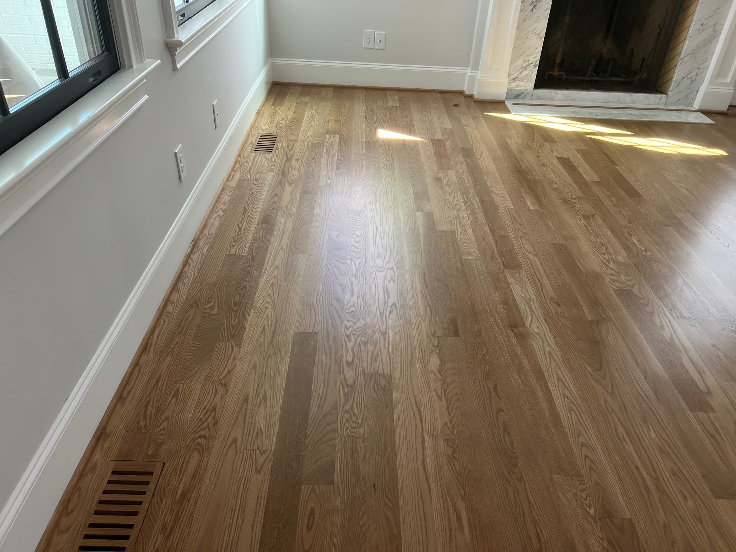Custom flush mount hardwood floor vent installed flush with surrounding boards Clayton NC