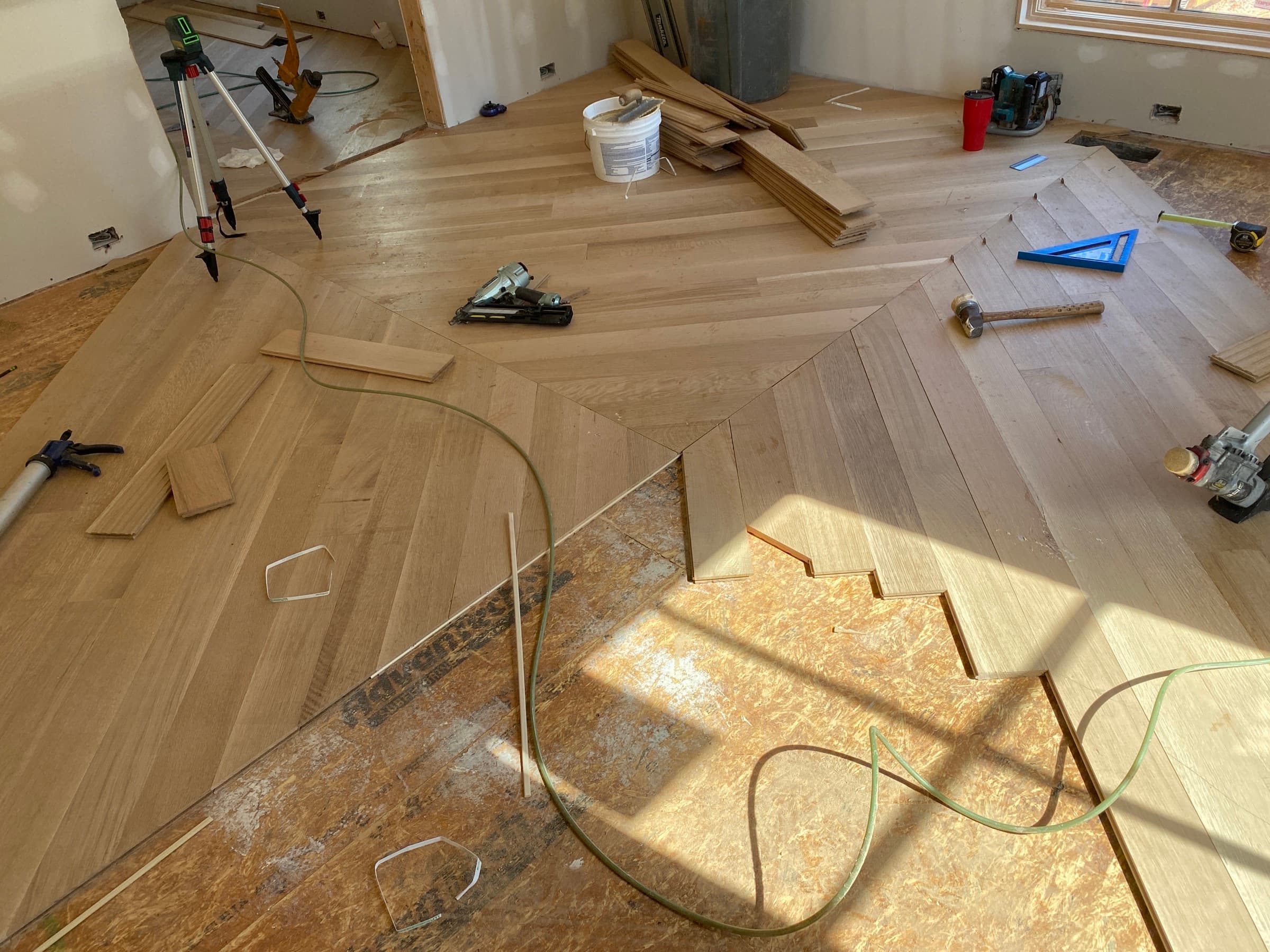 White oak hardwood floor installation in progress with herringbone pattern Clayton NC