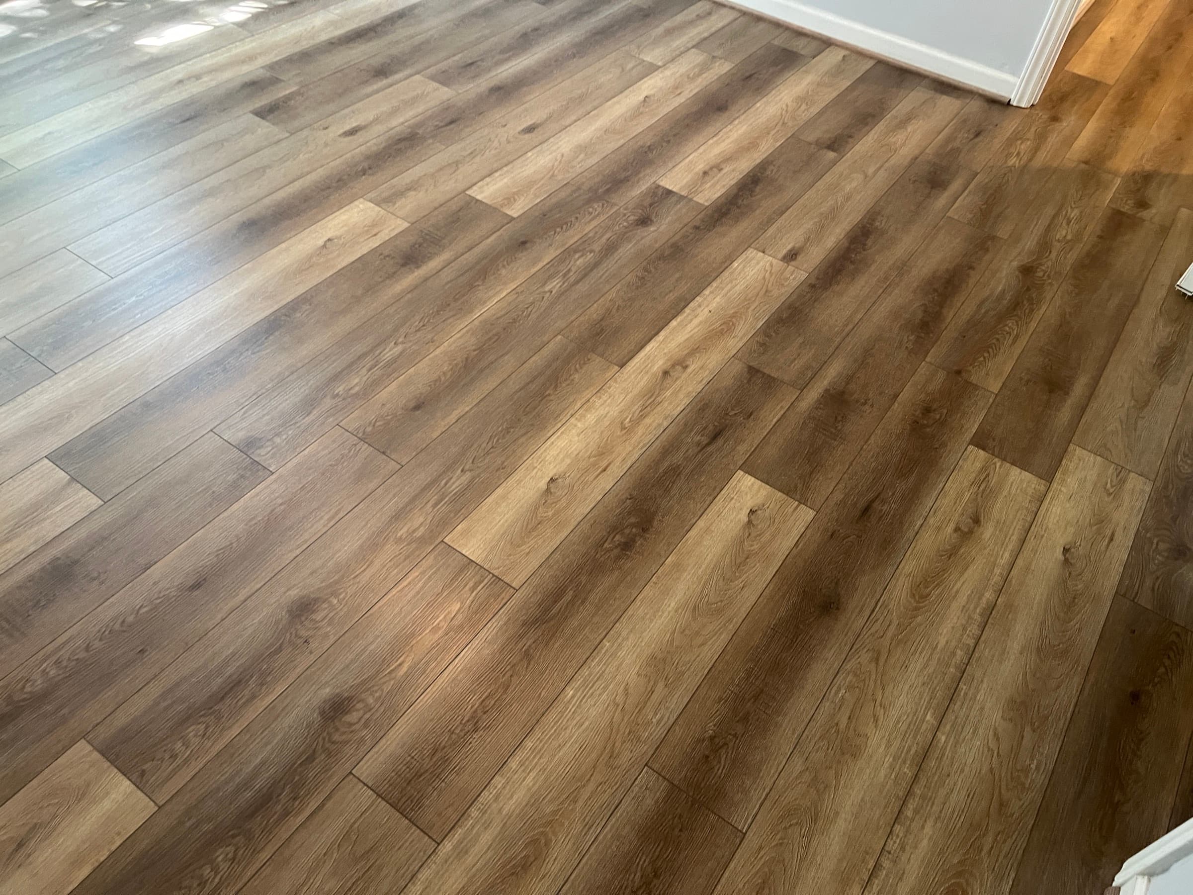 LVP flooring installed warm oak look planks Clayton NC