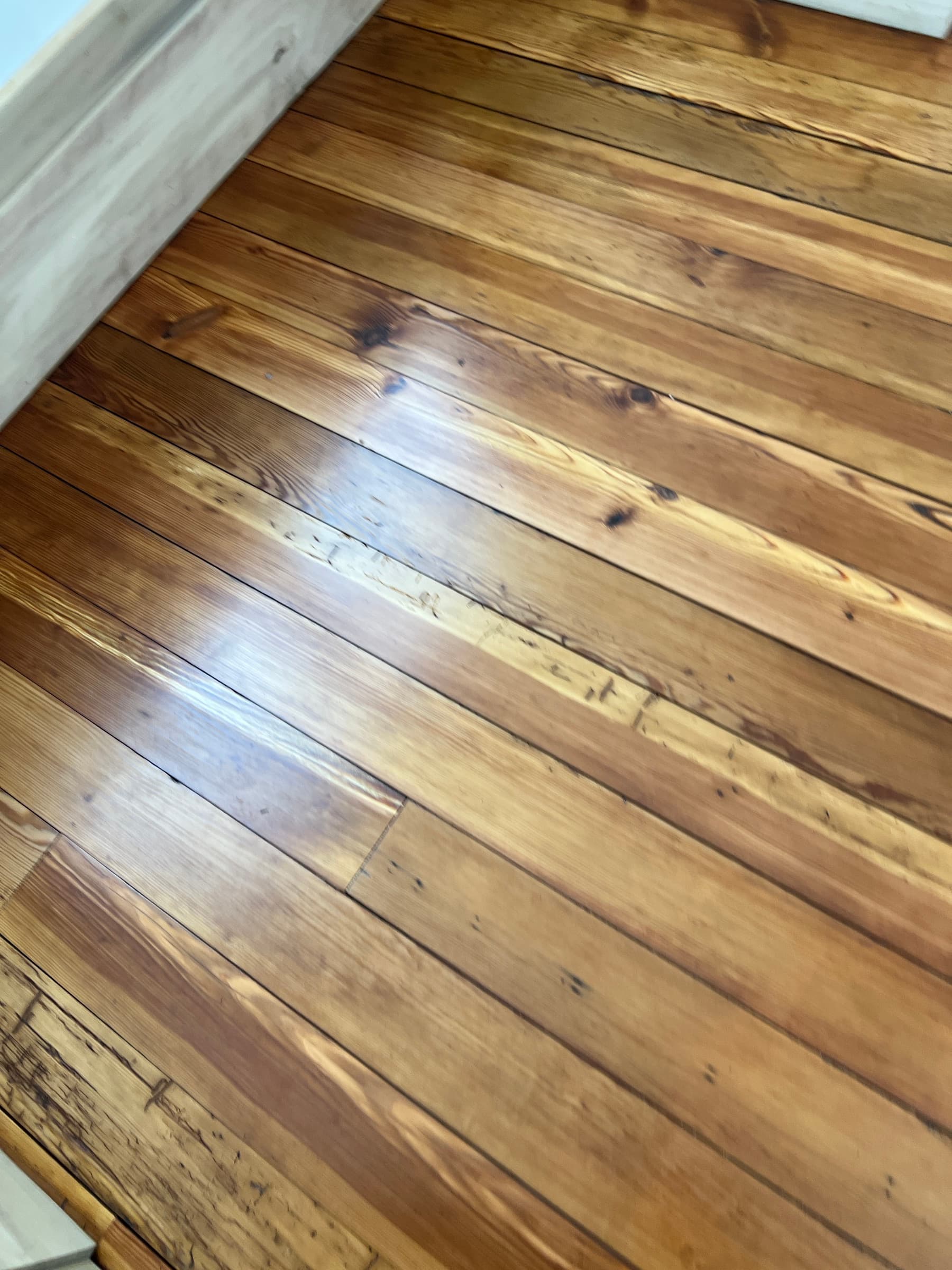Finished 100-year-old heart pine floors after refinishing in Morrisville NC, tinted water-based finish, knots and character preserved
